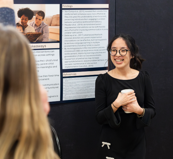Grad student presenting her academic poster
