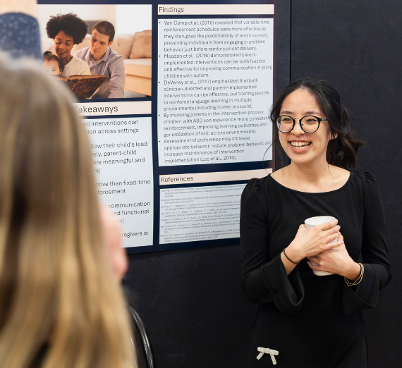 A student presents her poster at the Second Annual Diversity and Social Justice Conference.