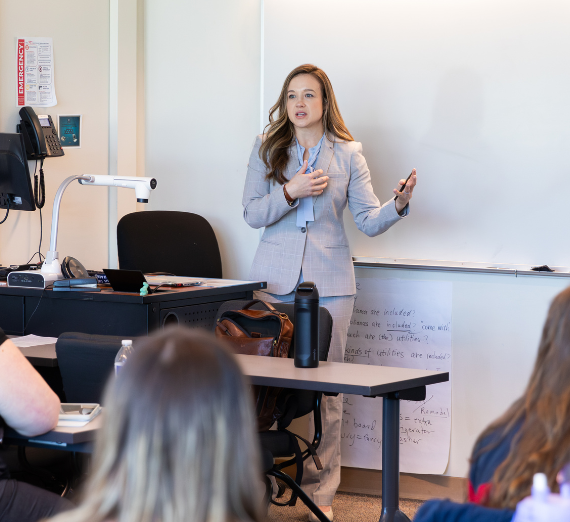 Faculty member teaching a class of grad students