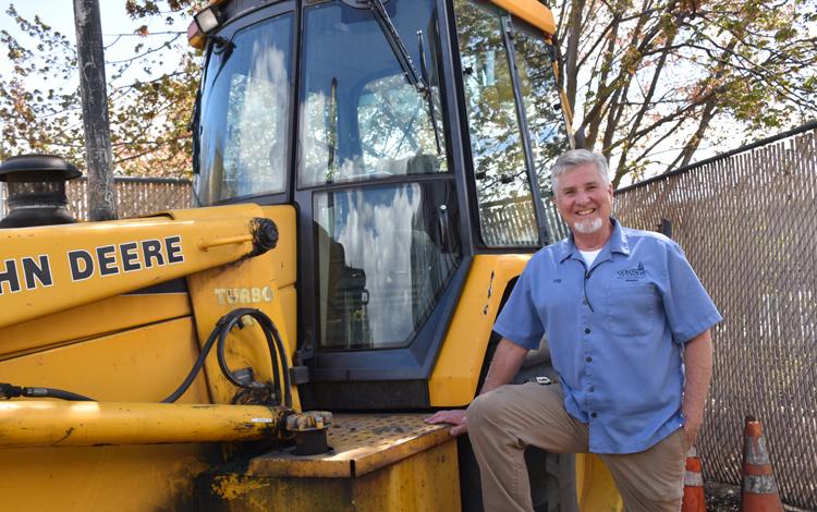 Tye McGee, Groundskeeper Supervisor outside with a tractor.
