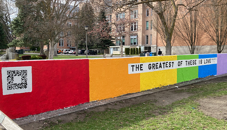 Rainbow painted wall with the phrase, "The Greatest of These is Love"