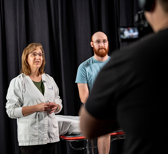 Nursing faculty are filmed by members of the IDD team