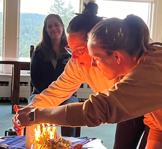 Participants extinguish candles during Healing Service on retreat