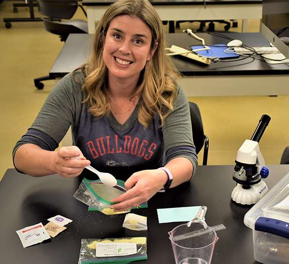 faculty member prepares materials for home lab studies