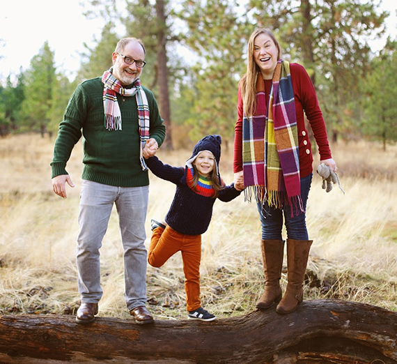 man and woman holding hands with child