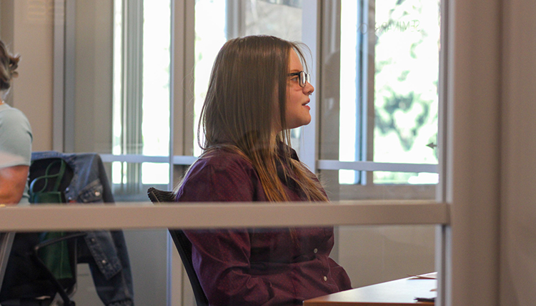 Person sitting and looking out window.