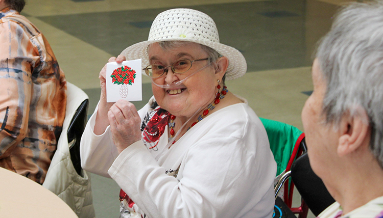 Woman holding up a craft.