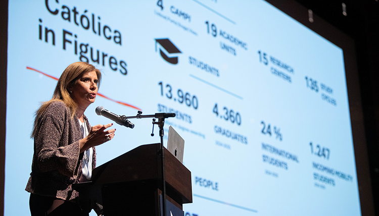 A woman stands at a podium