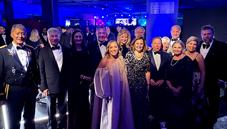 A group of men and women in formal attire