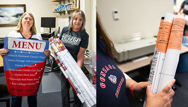 Two women pose with printed material.