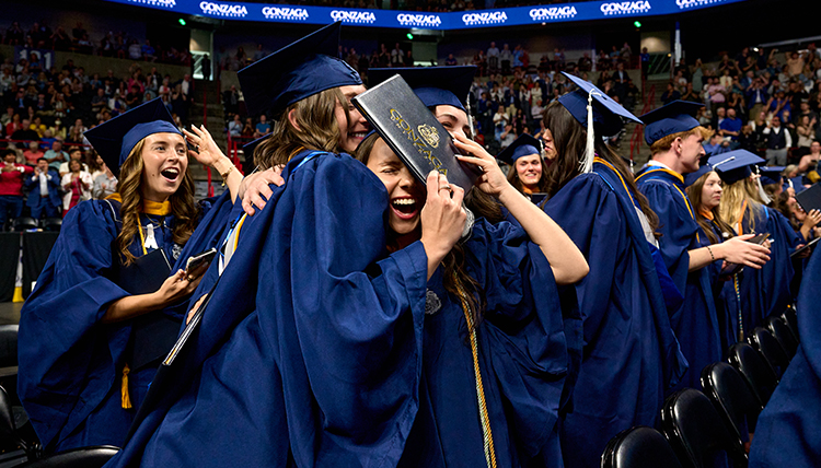 Students hugging at Commencement.