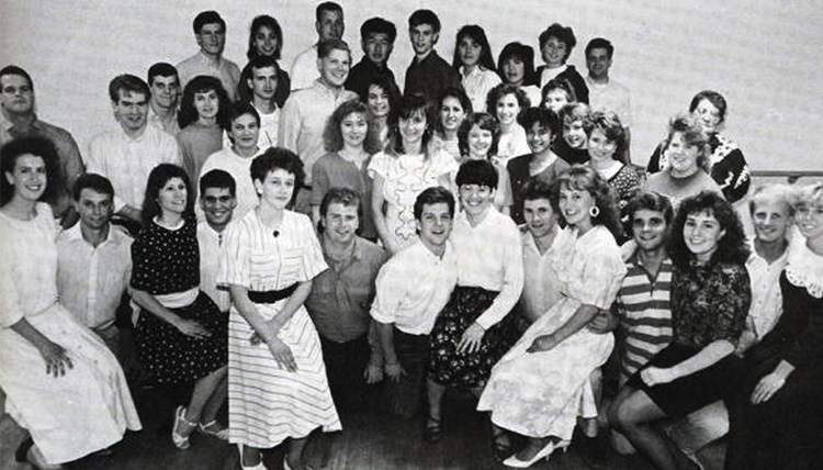 A group of students poses and smiles for a black and white photo.