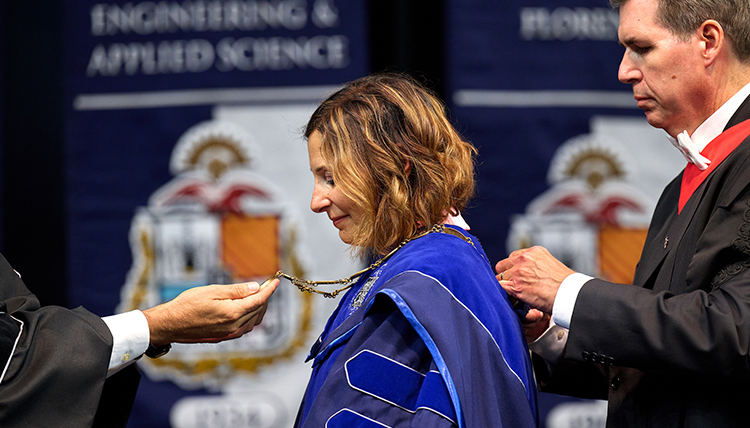 Passerini receives the chain of office at her inauguration.