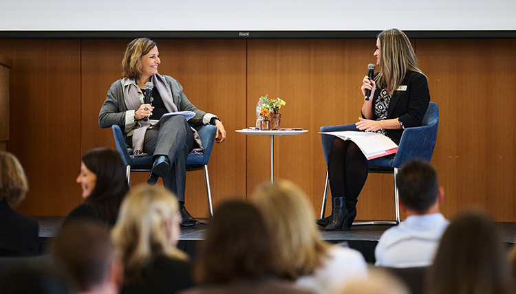 Dr. Passerini answering questions on stage at the Women Lead Luncheon.