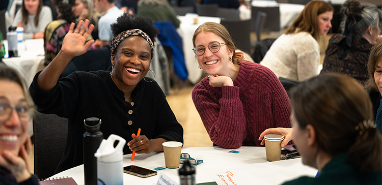 People smiling at a table.