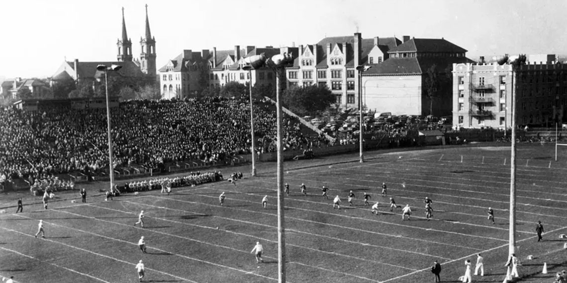 An historic image of the former football field on Gonzaga's campus, with St. Aloysius Church in the background