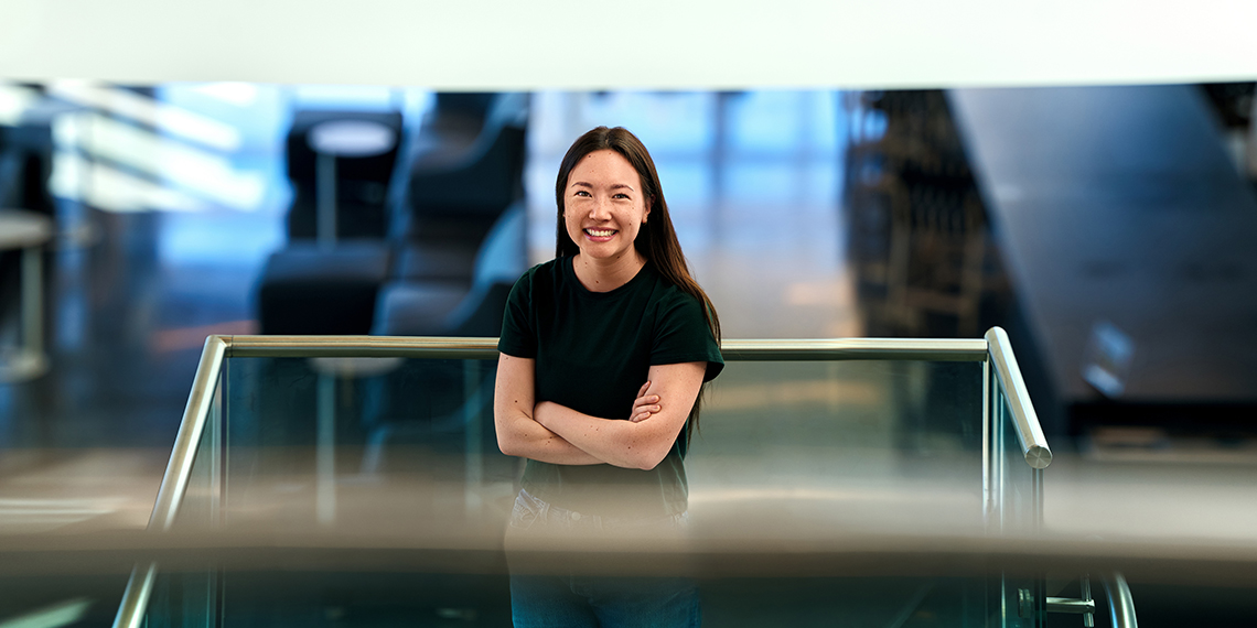 A woman stands with her arms crossed