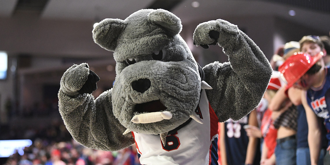 Gonzaga's mascot Spike flexes for the camera during a basketball game.