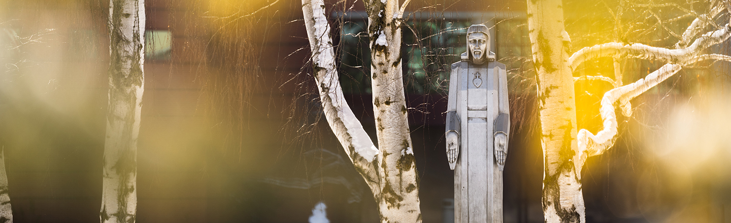 Fall leaves and a statue of Jesus.