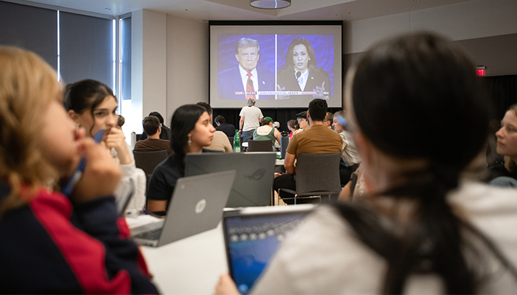 students watch the presidential debate on big screens