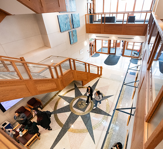 Students walk into the law school on a bright and sunny day. 