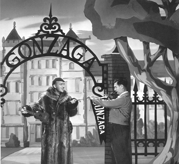 Bing Crosby stands underneath a sign saying  Gonzaga