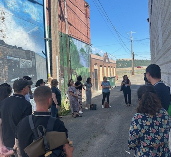 Students gather in an alley for a class.