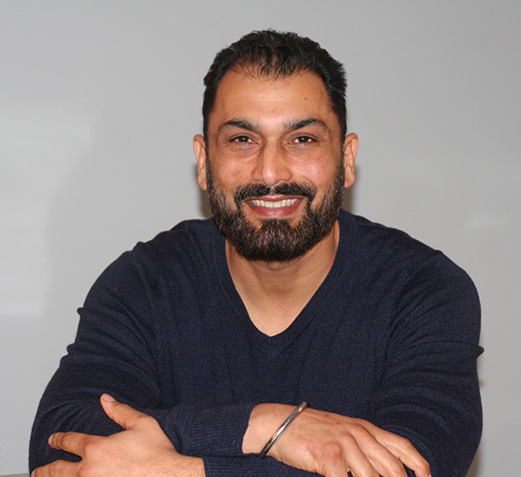 a man sits with his arms crossed