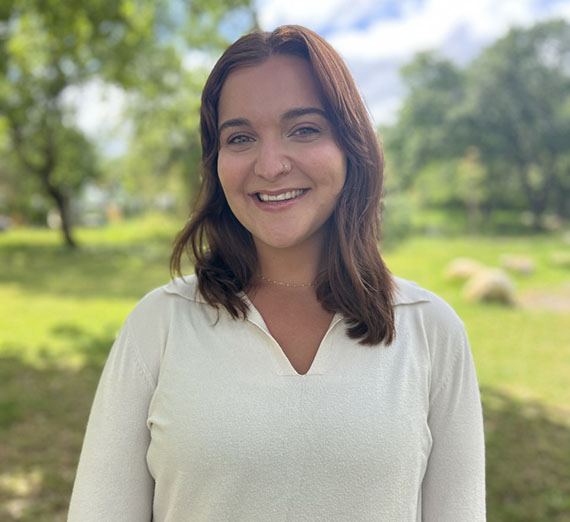 Samantha Karp Headshot with outdoor landscape behind her 
