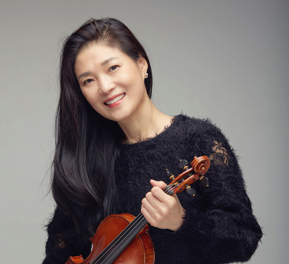 Internationally acclaimed soloist, Kyun Sun Lee, holding a violin.
