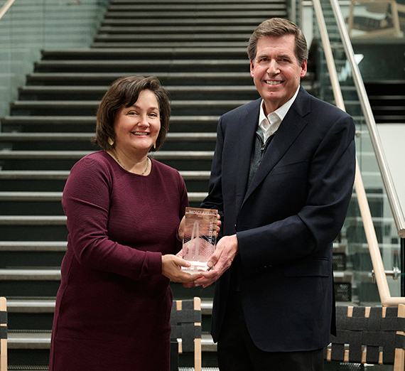 woman presents man with award