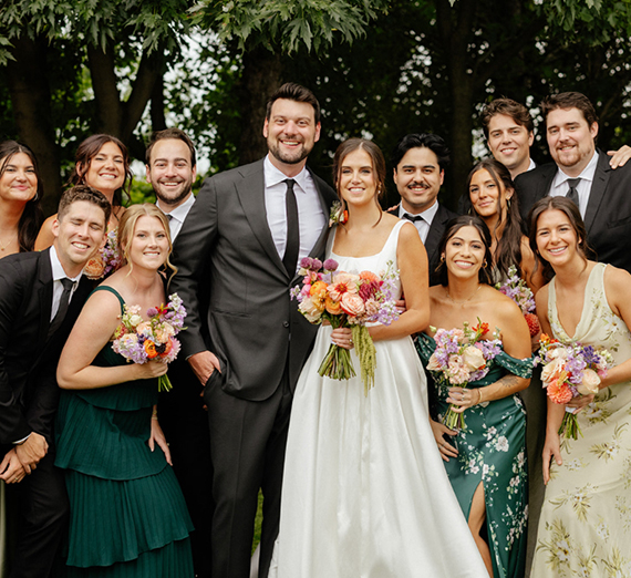 People smiling at a wedding.