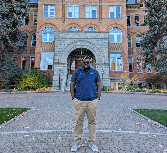 Caleb Jn. Pierre standing in front of College Hall