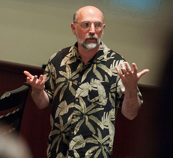 Physics Professor Eric Kincanon speaking at a lecture.