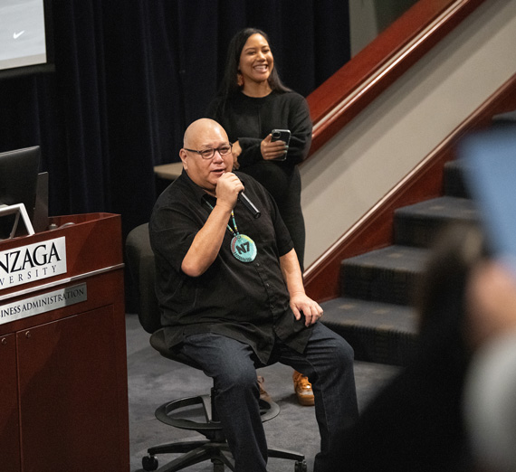 Sam McCracken and Izzy Yasana speak at the School of Business's Fireside Chat.
