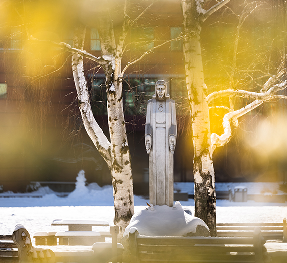 Fall leaves and a statue of Jesus.