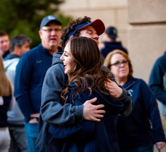 Students hugging outside of WCC tournament.