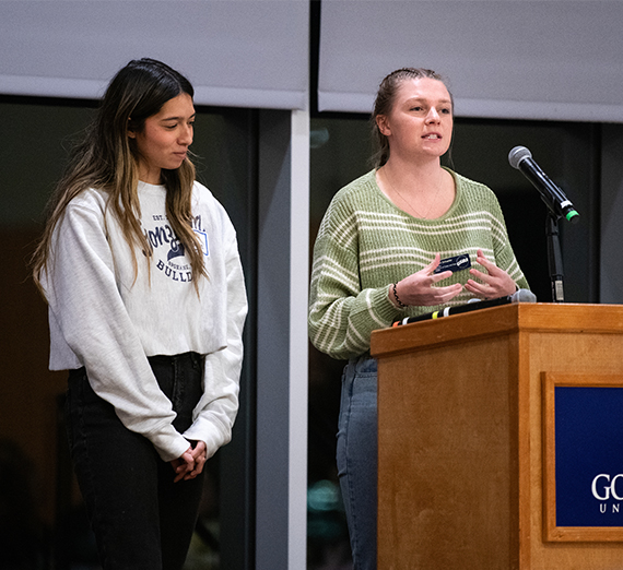 two students at podium