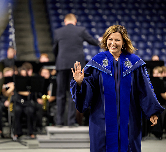 Dr. Katia Passerini walks down the aisle at Inauguration.