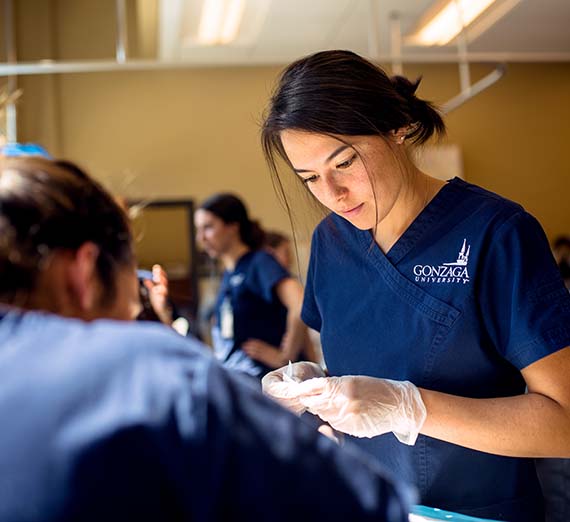 Nursing student in a lab environment.
