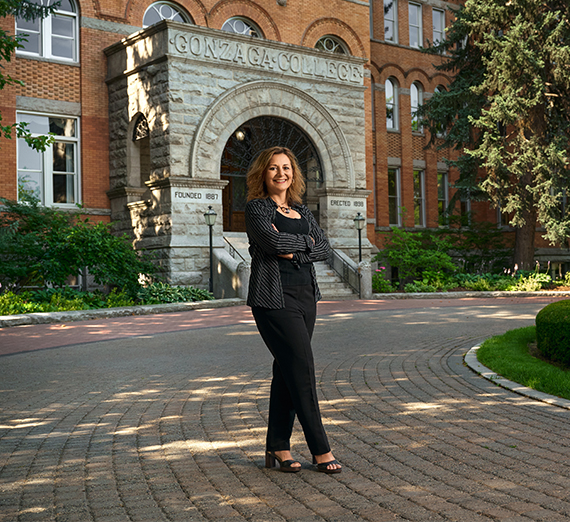 president in front of GU college hall