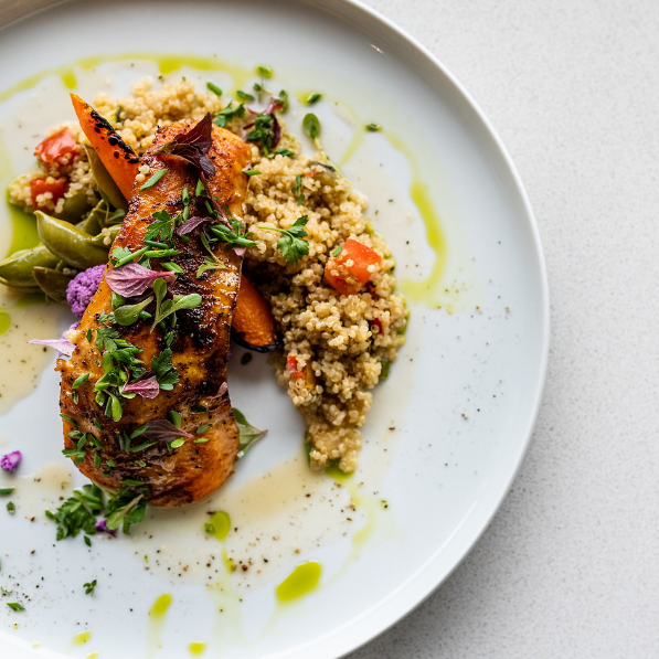 COG Salmon on a bed of quinoa and snap peas.