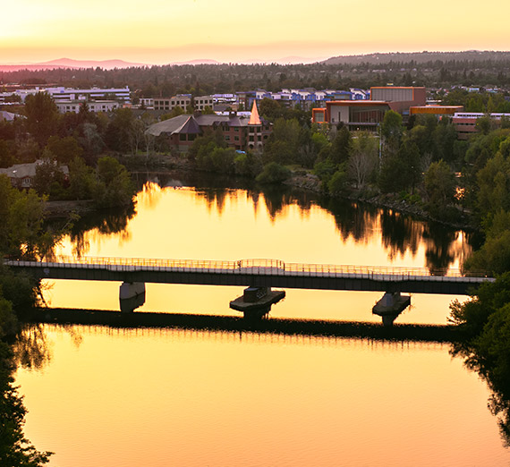 The Spokane River is illuminated with the sunset sky’s reflection.