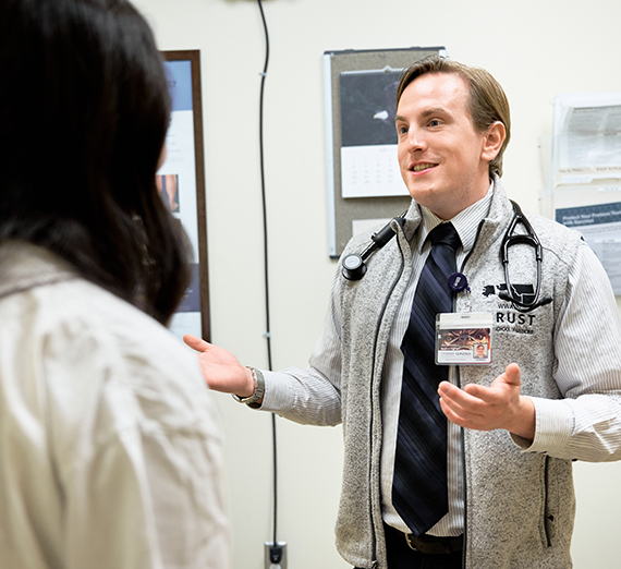 male doctor visits with patient in office setting