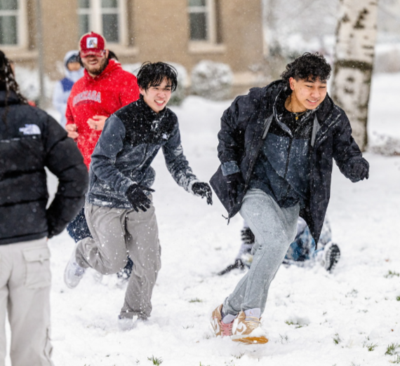 Students playing in the snow on Gonzaga's campus near Foley Lawn.