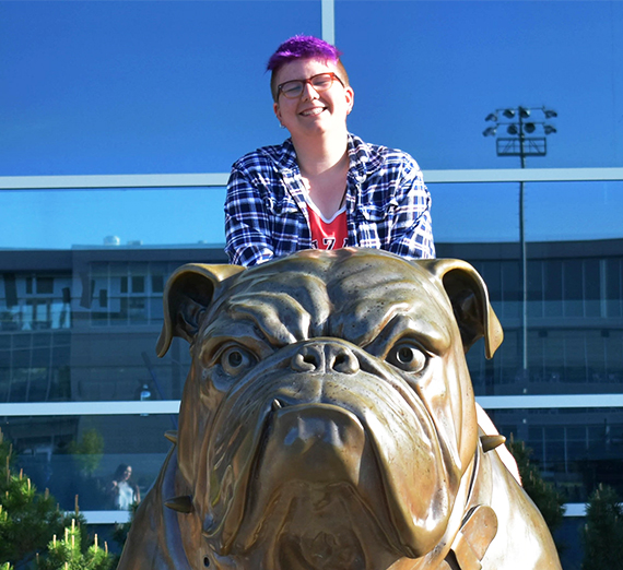 person smiling on sculpture of Spike the Bulldog 