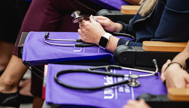 Health students of UW-GU health partnership with stethoscopes.