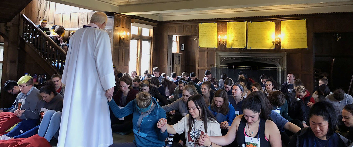 students praying together on retreat