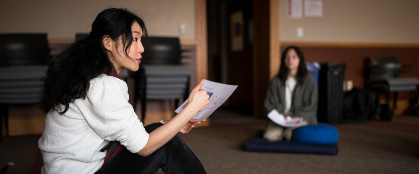 Dr. Gloria Chien instructing a meditation class.
