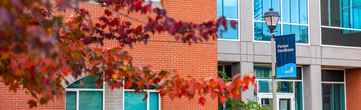 The school of education building with a banner that says Pursue Excellence